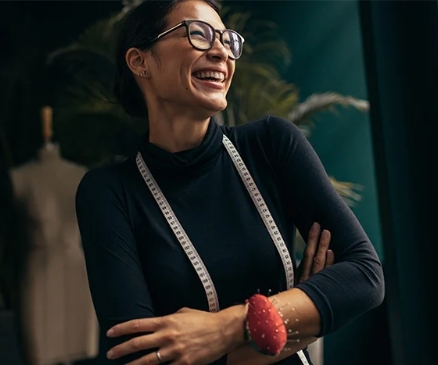 a woman wearing glasses with a smile