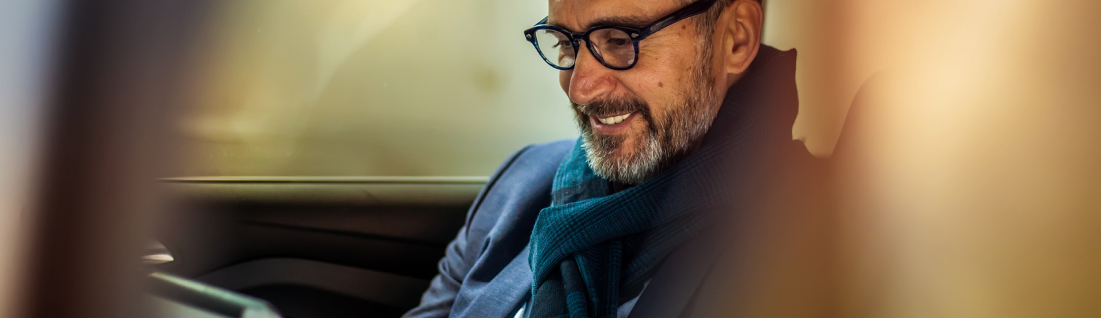 Business man in a car using a tablet