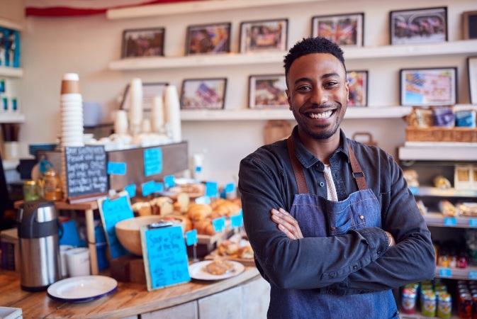 a business owner standing in front of the counter