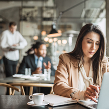 Business person working on a laptop at the coffee shop.