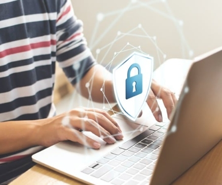 a person on a laptop with a security lock icon image