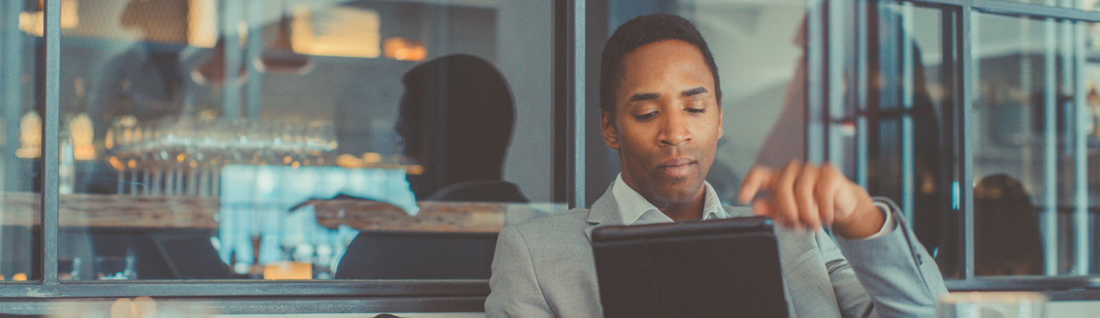 Business man using tablet in a restaurant